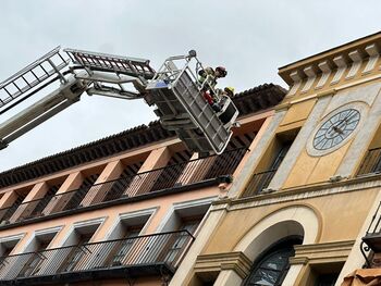 Bomberos sanean un revoco en el reloj del Arco de la Sangre